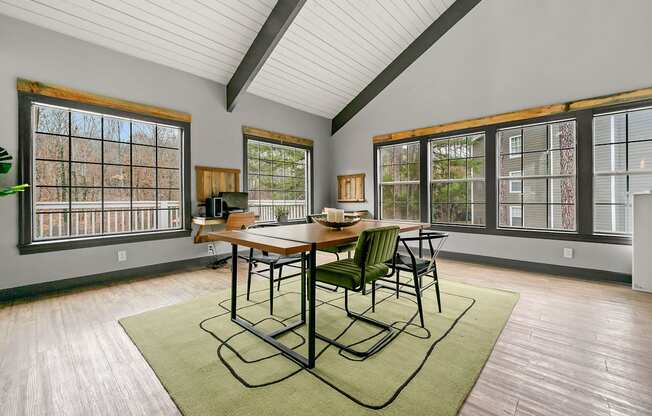 A dining room with a wooden table and chairs.