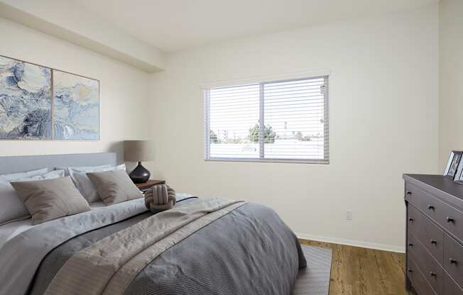 a bedroom with a large bed and a window