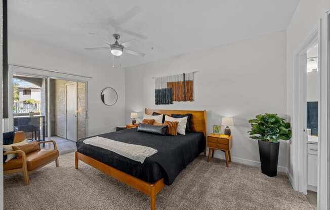 a bedroom with a bed and a ceiling fan