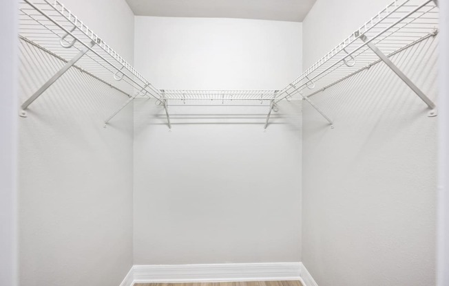 our spacious walk in closets are equipped with wire shelving and a wood floor