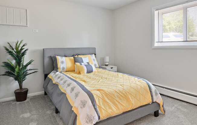 Bedroom with large window for natural lighting at Aspen Ridge Apartments in West Chicago Illinois 60185