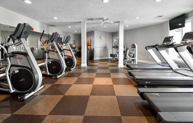 a spacious cardio room with treadmills and ellipticals