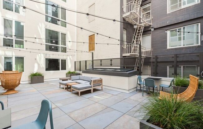 Outdoor lounge space with furniture at TL Residences