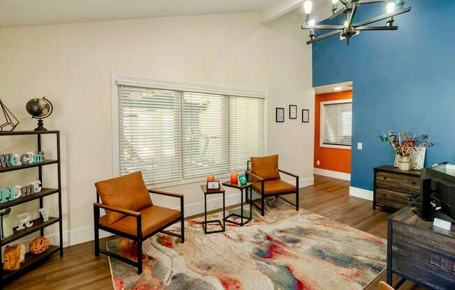 A leasing office with chairs and white and blue walls.