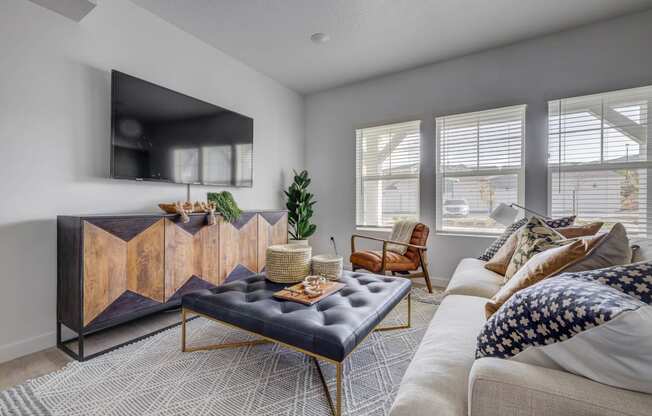 a living room with a couch and a coffee table in front of a tv