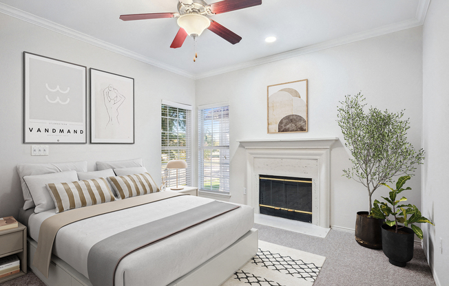 a bedroom with a bed and a fireplace at La Ventura Apartments, Plano, Texas