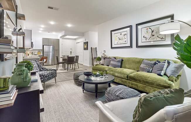 a living room with a green couch and a table