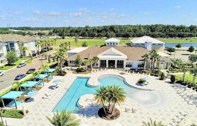 Beach-entry saltwater pool with splash pad, volleyball net, swim lane and cabanas