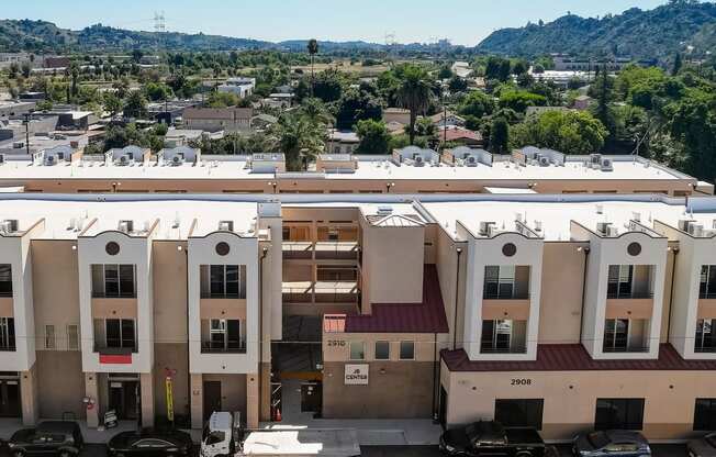 arial view of a building with cars parked in front of it