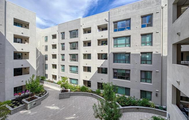 Courtyard with greenery and curved pathways offering fresh air, quiet moments, and room for lawn games.