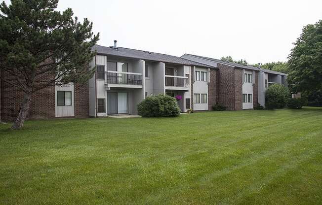 Courtyard and Building Exterior at Three Oaks Apartments in Michigan