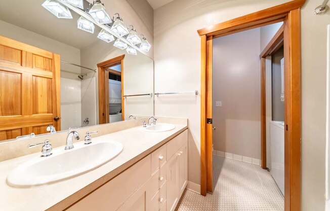 A bathroom with a vanity and a mirror.