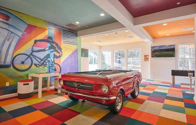 a pool table in a room with a car at Residences at Stevens Pond, Saugus