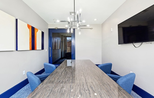 Professional conference room with a large table and chairs at Harlow River Oaks apartments in Houston, TX