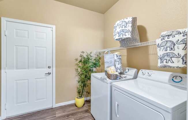 the washer and dryer in a laundry room with a white door