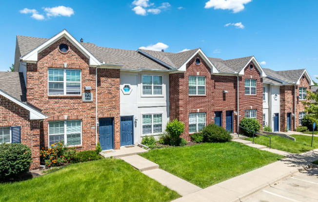 A row of houses with blue doors and windows.