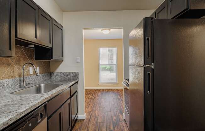 a kitchen with a sink and a refrigerator