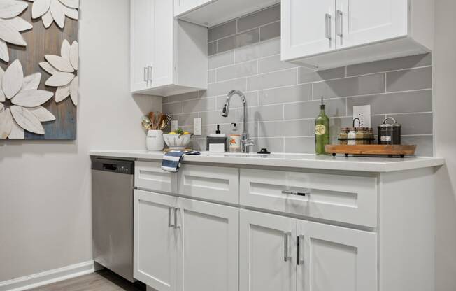 a white kitchen with white cabinets and a stainless steel dishwasher at St. Andrews Reserve, North Carolina, 28412