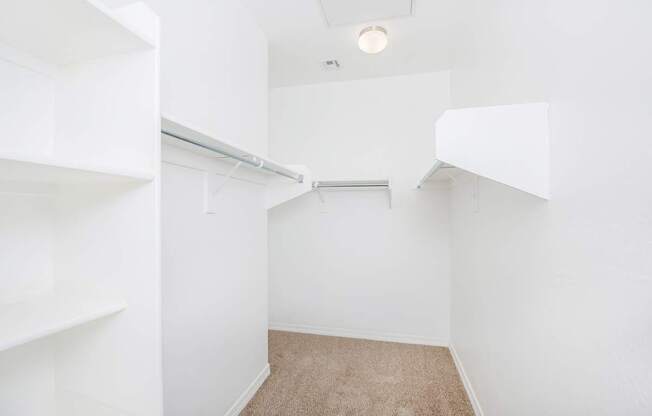 A small, empty room with white walls and a carpeted floor.