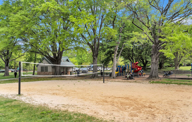 a park with a playground and trees and a house