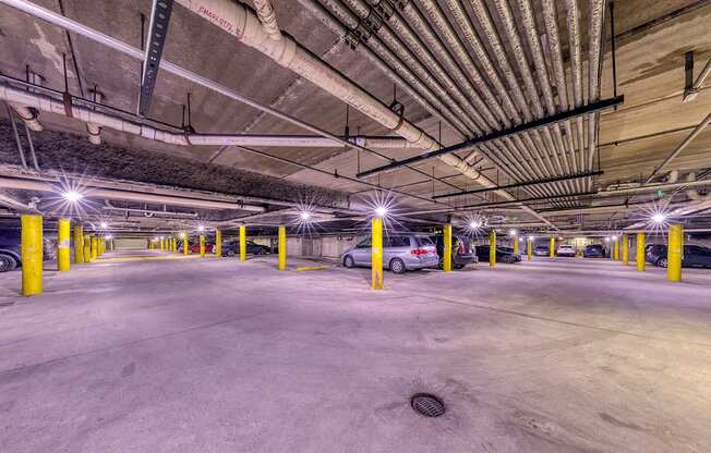 A parking garage with a car parked in the middle.