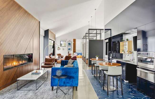 A modern living room with a fireplace and a blue couch.