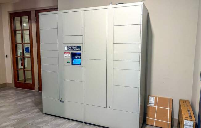 Secure package lockers at The Dorset Apartments with digital screen for convenient resident access.