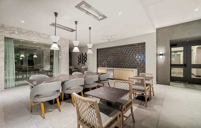 Elegant indoor lounge with marble accents, designer lighting, and flexible seating for dining or entertaining