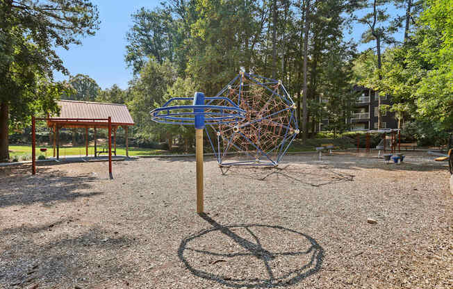 A playground with a blue and brown climbing structure.