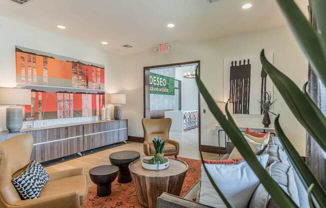 A living room with a couch, chair, and a table with a pineapple on it.