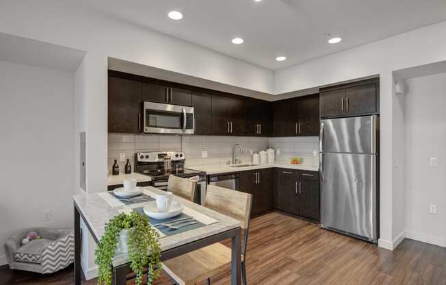 Apartments for Rent in Hollywood, CA - Kitchen With Hardwood Floors Featuring Convenient Amenities Such as Fridge, Stove, and Microwave