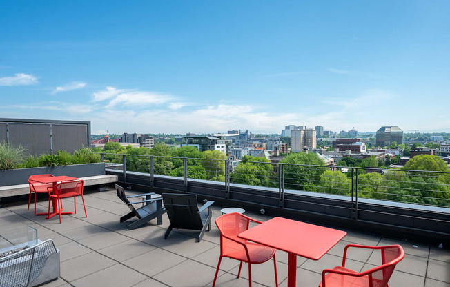 a terrace with tables and chairs and a view of the city