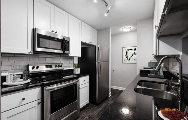 a kitchen with a stove top oven next to a sink