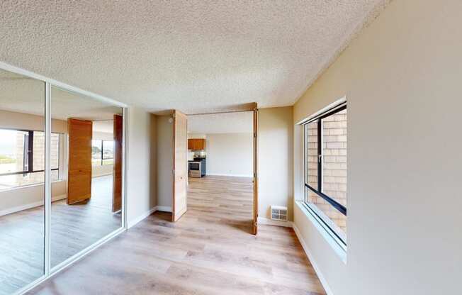 a view from the living room into the kitchen and dining room