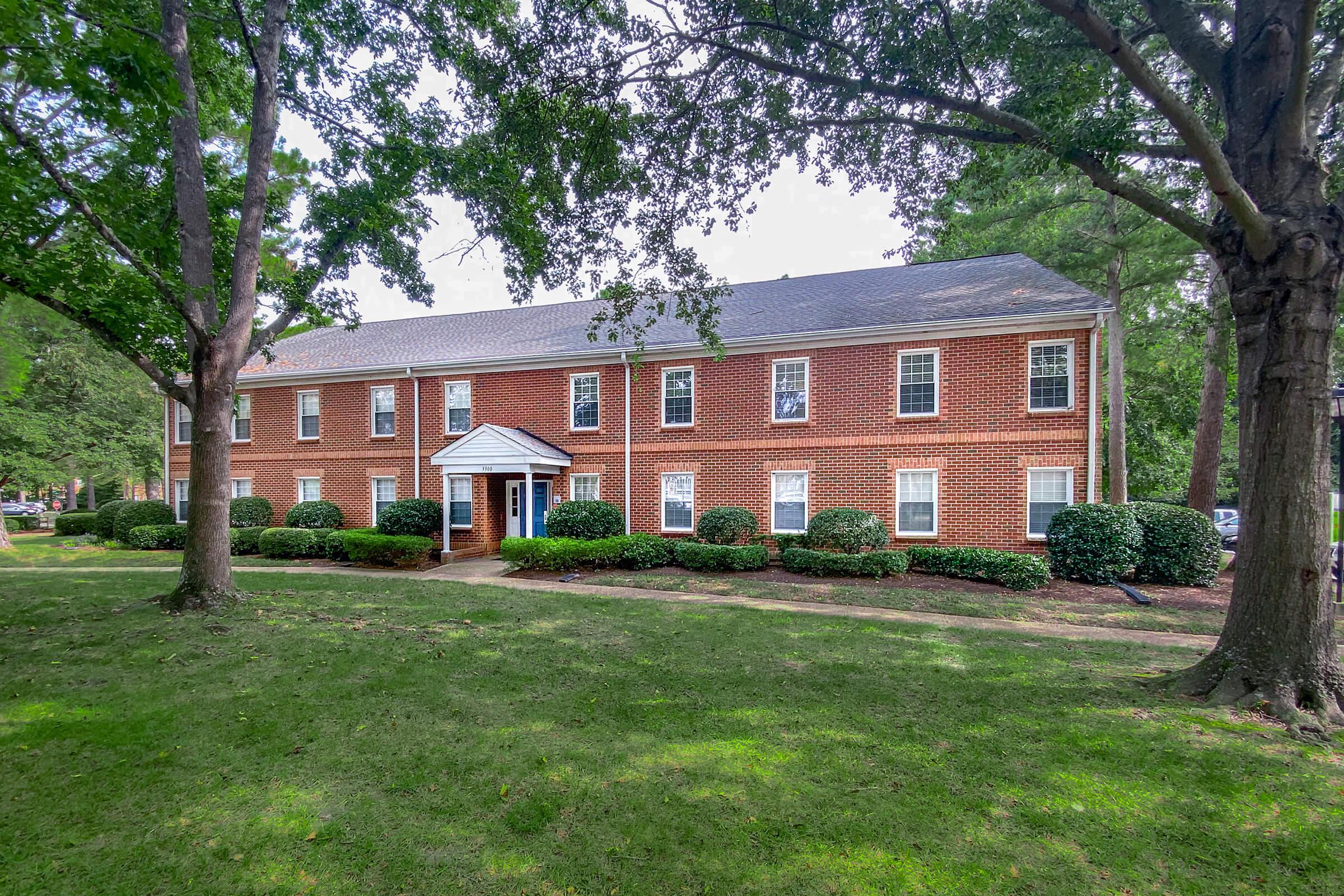 a large lawn in front of a house with Kenmore in the background