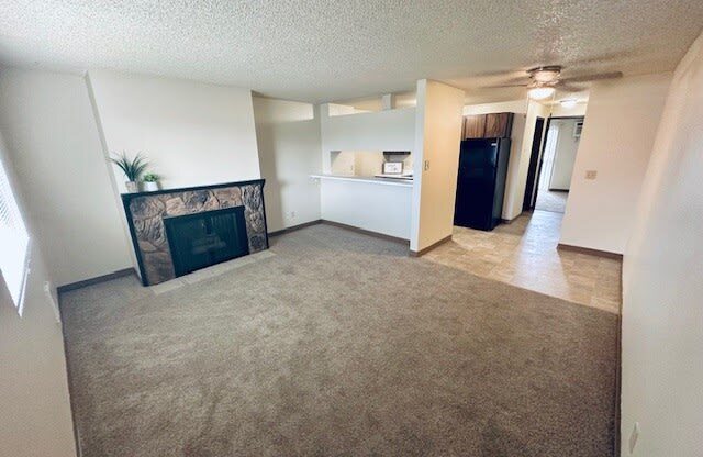 an empty room with a view of a lobby and a staircase