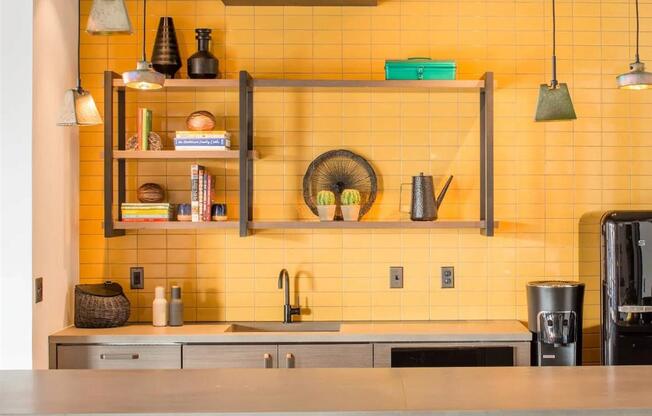 a kitchen with yellow tiles and bar stools