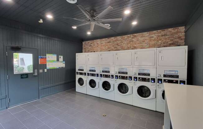 a laundry room with a bunch of washers and dryers