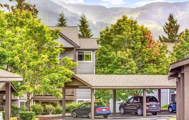 a view of a building with cars parked in a parking lot