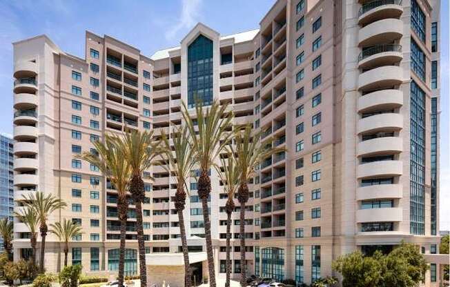 A large building with a courtyard in front of it. at Towers at Costa Verde Apartments, California