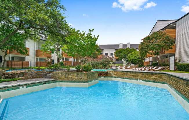 a swimming pool at an apartment building with a blue pool