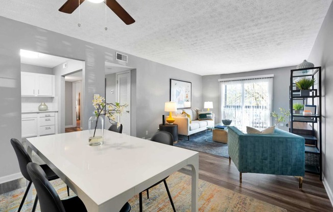 an open living room and dining room with a white table at Station JTown, Kentucky, 40299