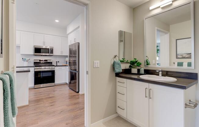 a kitchen with a sink and a mirror