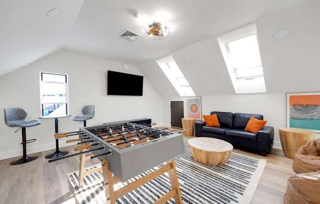 A foosball table is in the middle of a living room.