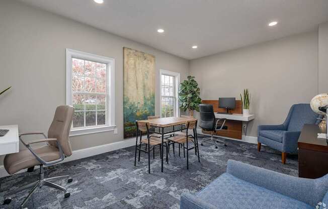 A room with a blue chair and a desk with a computer.