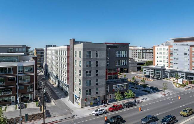 an aerial view of a city with buildings and cars on the street