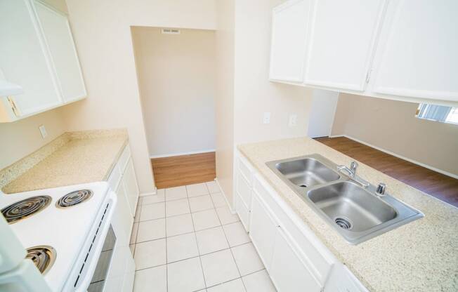 a kitchen with a sink and a stove