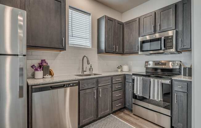 Kitchen with Dark Brown Cabinetry and Stainless Steel Appliances