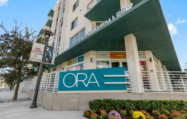 a sign for the ora hotel in front of a building
