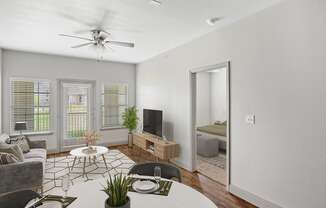 a living room with white walls and hardwood floors